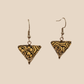 Black and Gold triangle geometric origami earrings with a floral and geometric pattern on a beige background