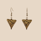 Black and Gold triangle geometric origami earrings with a floral and geometric pattern on a beige background