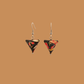 Black and Red triangle geometric origami earrings with a floral and geometric pattern on a beige background