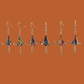A pair of blue, purple, orange origami lily earrings with a floral and geometric pattern on an orange background