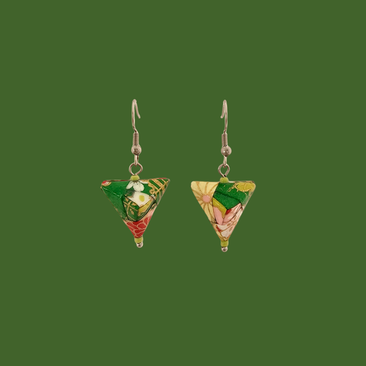 Green, pink, and gold geometric origami earrings with a floral pattern on a green background.