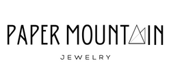 Paper Mountain Jewelry Logo. Paper Mountain written in all caps. A in Mountain is replaced with a graphic of a folded piece of triangular paper. 