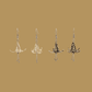 White and gold origami lily earrings with a floral and geometric pattern on a beige background