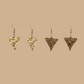 White and Gold triangle geometric origami earrings with a floral and geometric pattern on a beige background