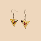 Yellow geometric origami earrings with a floral pattern on a beige background