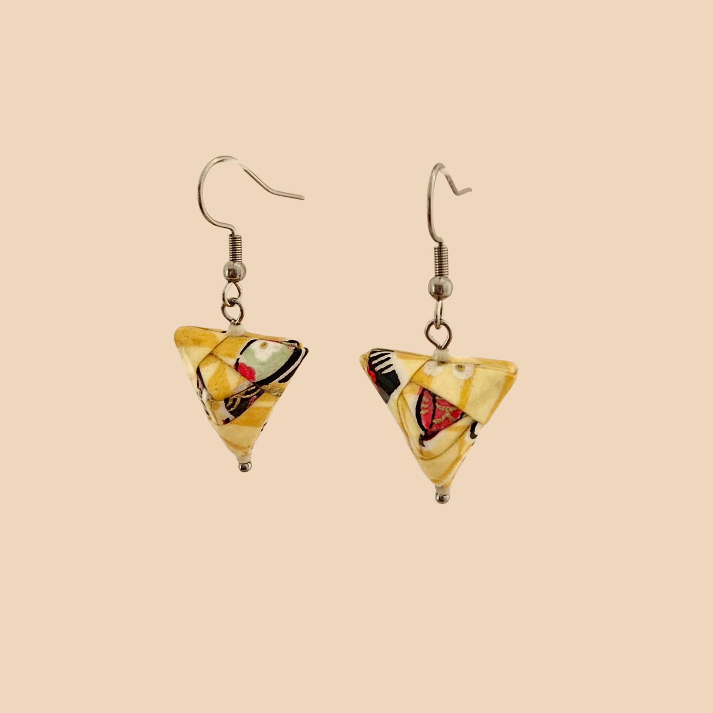 Yellow geometric origami earrings with a floral pattern on a beige background