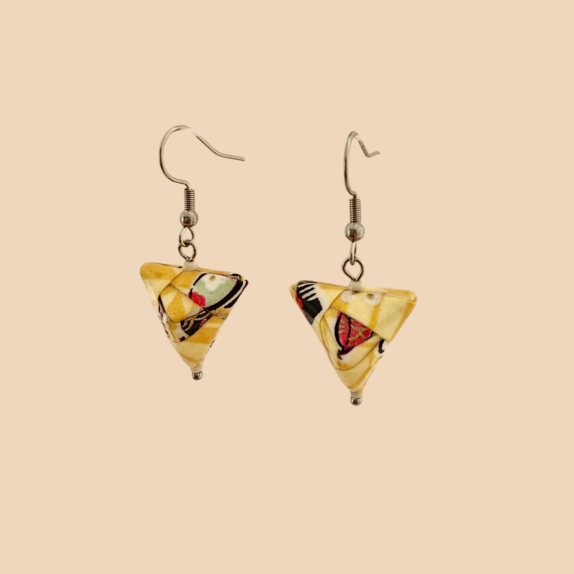 Yellow geometric origami earrings with a floral pattern on a beige background