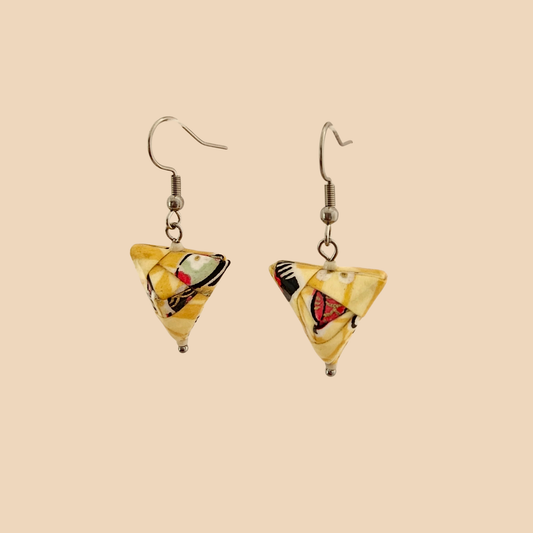 Yellow geometric origami earrings with a floral pattern on a beige background