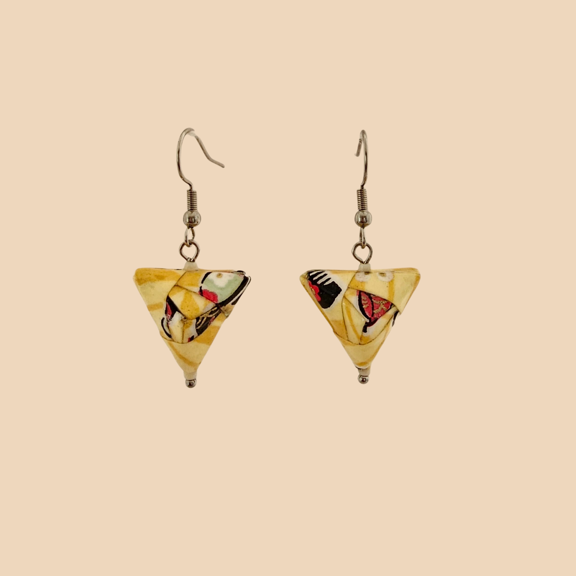 Yellow geometric origami earrings with a floral pattern on a beige background